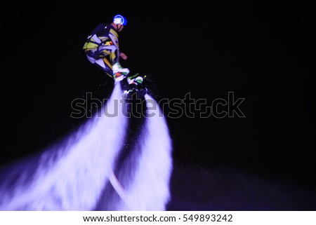 Water stunts performance at night in a park
