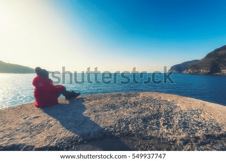 Woman with a travel enjoying, Sea in the Beautiful natural landscape in the winter time.