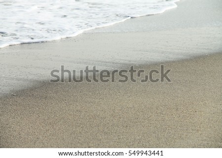 Oncoming wave foam on the beach. Black Sea.