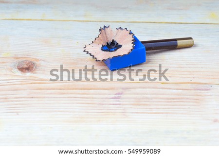 Pencil sharpener shavings on a wooden table. Back to school. Copy space.