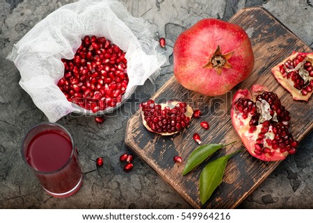 Pomegranate fruits with grains and leaves on the table. Make juice. Top view.