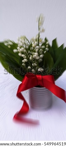 Aerial view bouquet of lily of the valley in watering can vase. Bunch of Convallaria majalis top view white blossoms green leaves perfect for interior decoration magazines. Image with filter effect