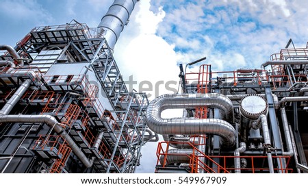 Close up Industrial view at oil refinery plant form industry zone with sunrise and cloudy sky Royalty-Free Stock Photo #549967909