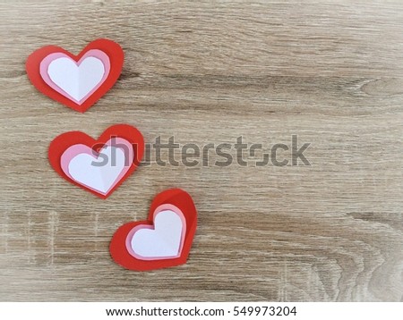Red Pink White paper hearts {Paper Heart stacked} isolated on wooden background. You can use for greeting card "Happy Valentine's Day"