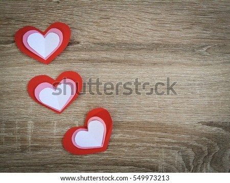 Red Pink White paper hearts {Paper Heart stacked} isolated on wooden background. You can use for greeting card "Happy Valentine's Day"