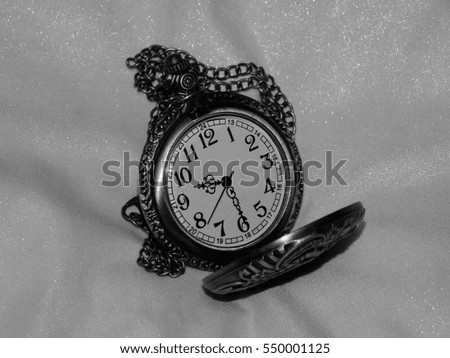 Antique pocket watch on a black and white photo