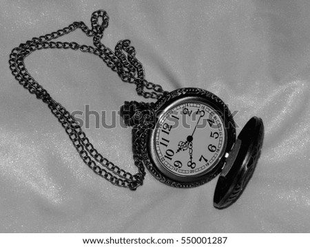 Antique pocket watch on a black and white photo