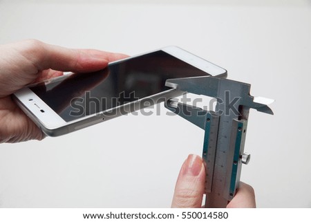 calipers measuring mobile phone