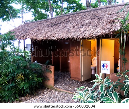 Toilet  with dry grass roof cover and tree is very beautiful