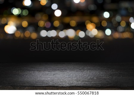 Empty wooden table platform and bokeh at night Royalty-Free Stock Photo #550067818