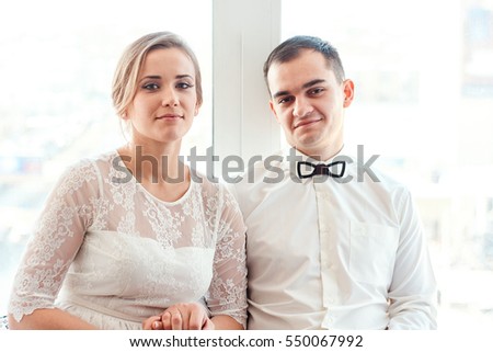 first date; wedding photo studio; Suite conversation. Look Suite. Black groom and beautiful bride blond girl with beautiful eyes and teeth.