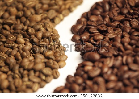Arabica and robusta coffee beans side by side Royalty-Free Stock Photo #550122832