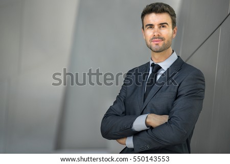 Businessman posing confident and positive in professional workplace office with space  Royalty-Free Stock Photo #550143553