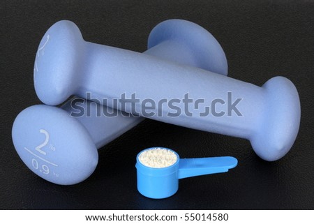 set of two pounds blue women dumbbell weights , and protein powder,the key of bodybuilding supplementation and nutrition