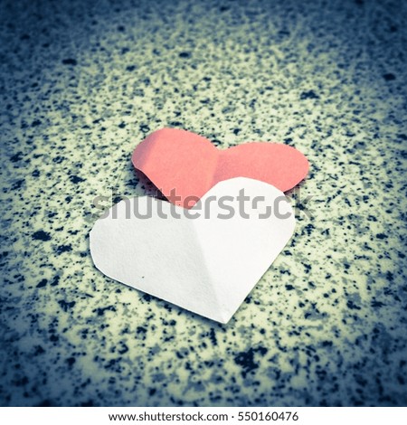 Retro grunge  Vintage old paper design of Folding  paper hearts {Paper stacked of folding hearts) on marble floors background. Greeting card "Happy Valentine's Day"