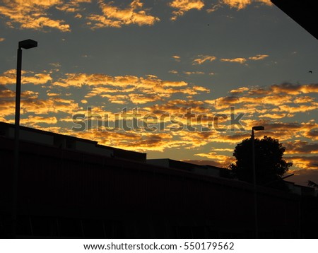 golden light cloudy dusk sky in winter morning with silhouette scene background, use shadow spot light metering 