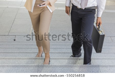 Moment Businessman and Businesswoman running fast upstairs.,image couple leg walking up stairs in city to success,Space for copy text. Royalty-Free Stock Photo #550256818