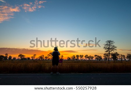 Shilouette girl in Fiery orange sunset sky. Beautiful sky.sunset in Thailand