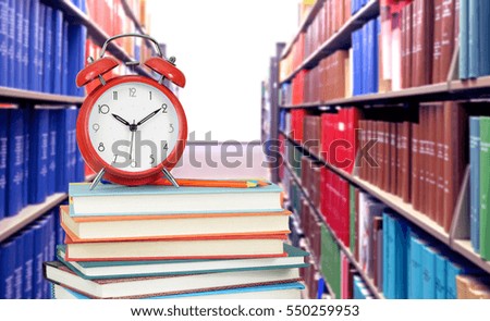 Education concept with stack of book in the very blurry library background