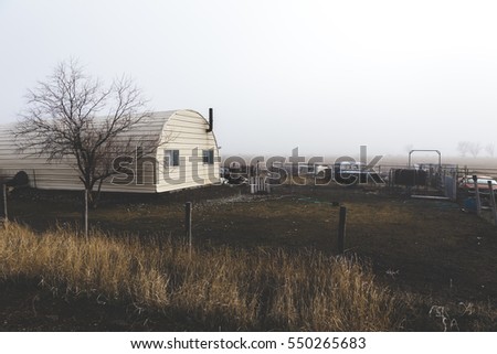 Rounded home in rural farming neighborhood. Foggy winter setting. Shoshone, Idaho, USA.