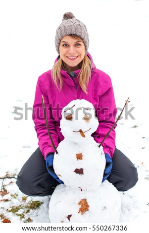 Picture of a cute young woman with a little snowman