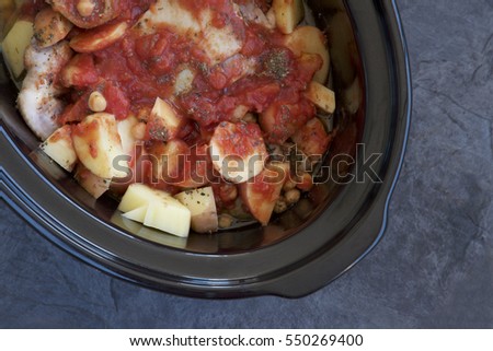 Slow cooker with chicken and vegetables. Royalty-Free Stock Photo #550269400