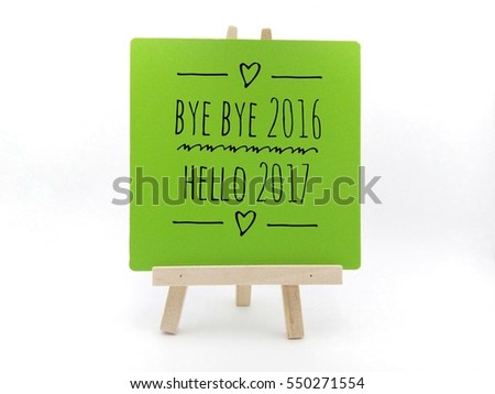  Conceptual image with word "BYE BYE 2016 HELLO 2017" on white green frame and wooden tripod  