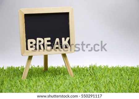 Sogn Break on chalk board is on green lawn.