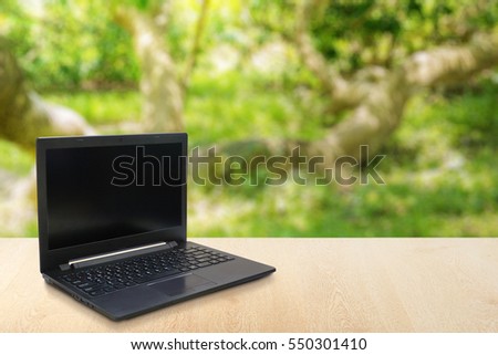 Computer Laptop on the table blur background with bokeh, business technology concept