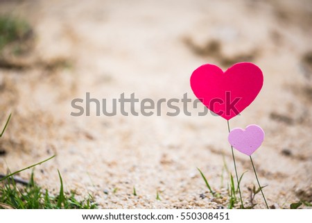 Vintage tone couple heart with blurred sand background for Valentines Day