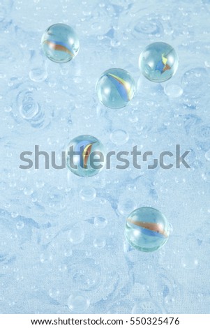 glass ball on blue water drops background