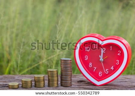 clock and Money Gold coin Steps green nature background.