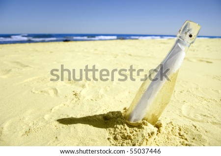 Message in a bottle on sand.