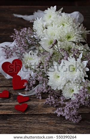 Aster flowers bouquet and valentines day red hearts