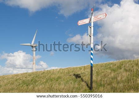 Wind turbine and traffic indicator for bicycles at a Dutch dike