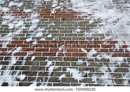 Paving slabs with snow in winter