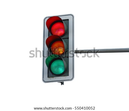 At a traffic light the three colors light up red, yellow and green at the same time. Royalty-Free Stock Photo #550410052