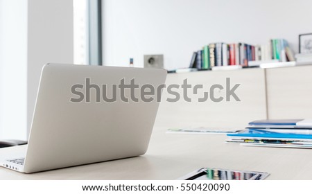 Laptop on desk in office