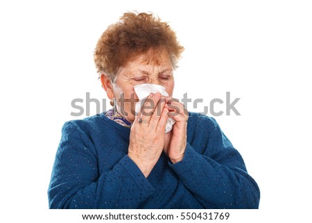 Picture of an elderly woman blowing her nose - isolated background