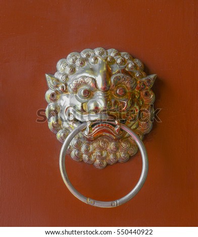 Chinese lion door knocker on red door