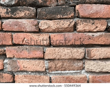 Red bricks with a white cement in big scale in old architecture in ancient temple, thailand.