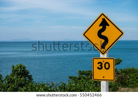 Traffic sign indicating a winding road must be using a limit speed.