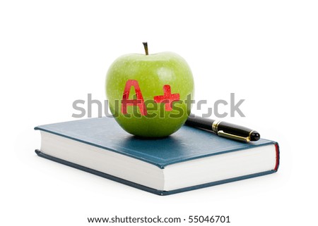 Green apple and Textbook close up