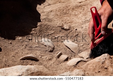 Archaeological tools, Archeaologist working on site, close-up, hand and tool. Royalty-Free Stock Photo #550477183