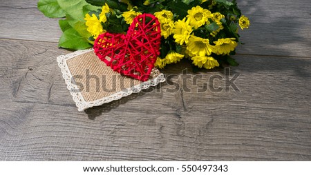 red heart and yellow flowers the concept of Valentine's day, gift, love, space, on wooden background