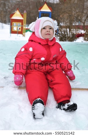 
Small child walking in the playground in the winter