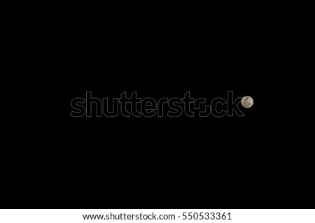 The full moon on the right side at night with black sky background.
