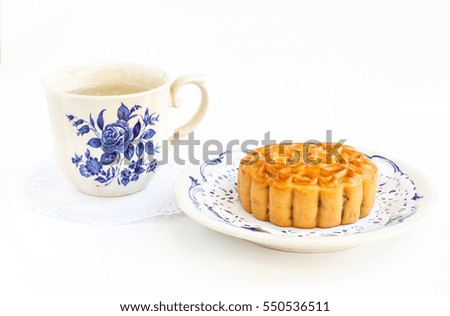 Traditional mooncake and tea, dessert for the Chinese mid autumn festival on white background
