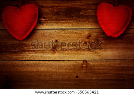 Burlap Heart Shapes on Wood Background - Photograph of burlap heart shapes on top of a genuine wood background with a photo filter on the image.  Blank space for text. Great for Valentine's Day 