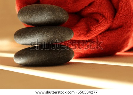 Stones, red towel on the wooden table